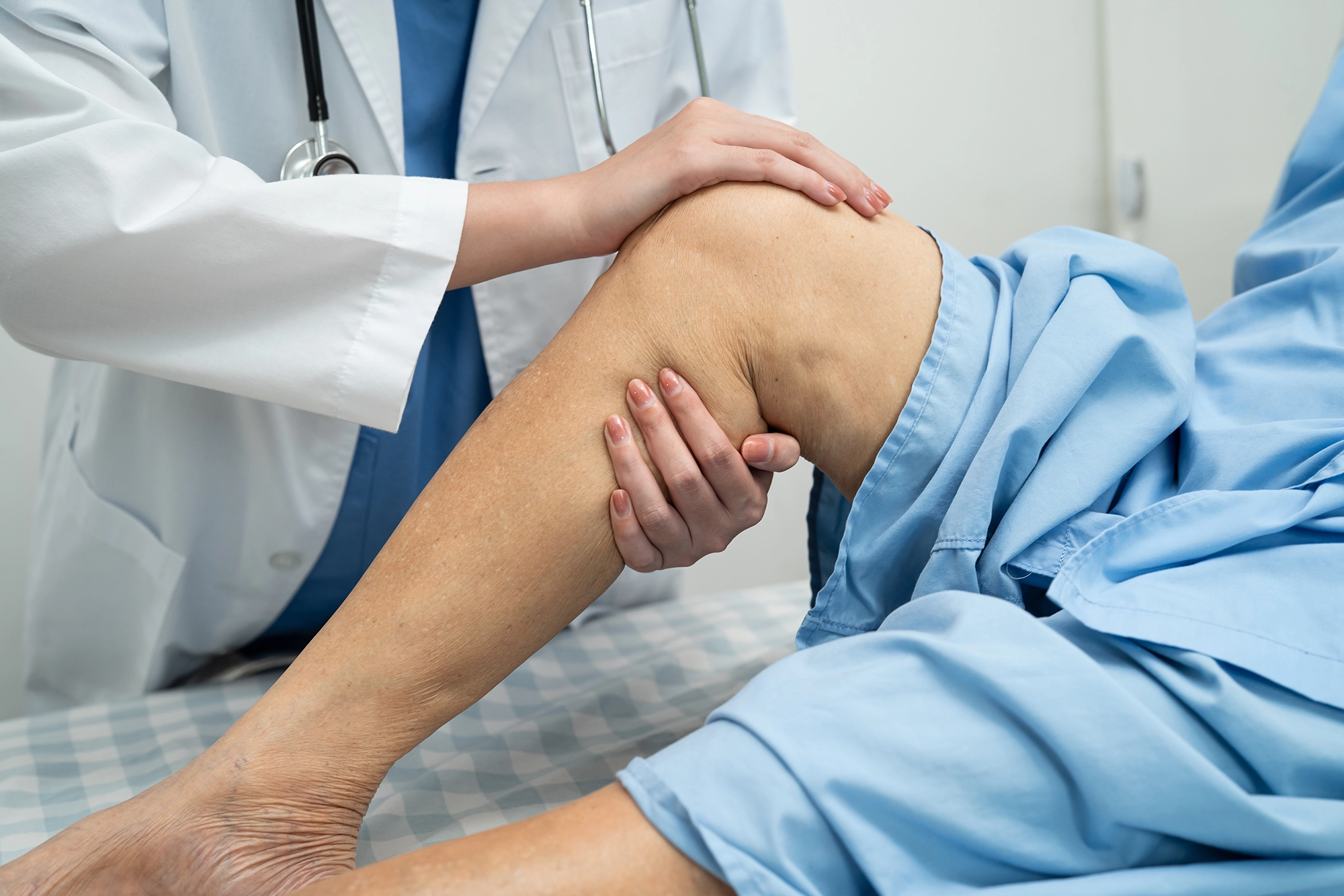 Doctor holding and assessing a patient's leg