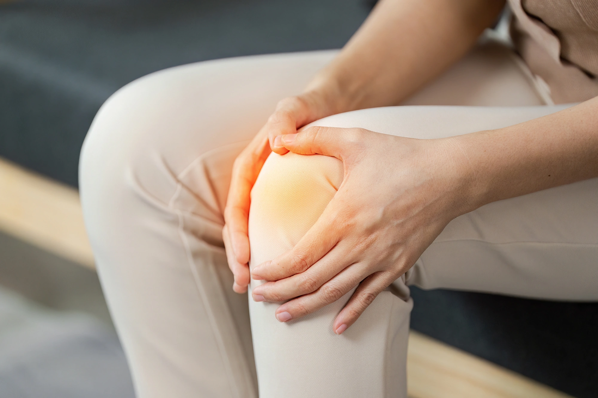 Person holding their knee in pain