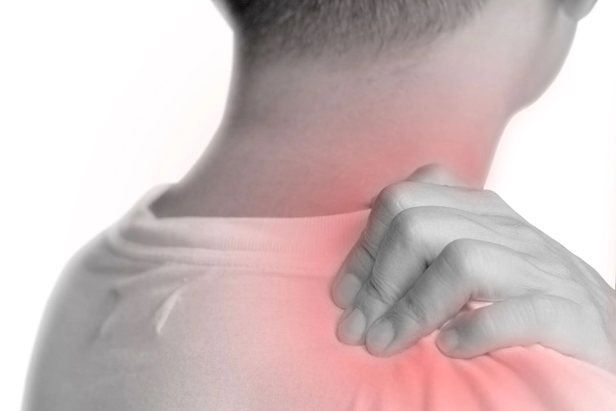 A man gripping his shoulder with a red glow symbolising pain or discomfort